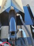 Root grapple clamp cylinder under the clamp shell, elbow fittings and hydraulic hoses on both ports