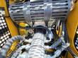 AGT CRT23 engine bay: shielded muffler above the engine, spin-on oil filter and braided hydraulic lines