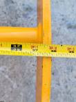 Tape measure across the yellow rake's frame, scale reading just past 38 inches