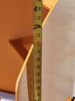 Tape measure up the snow blade's end plate, reading about 32 inches of overall height