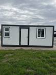 White 7x20 portable office with dark steel frame, center entry door and two sliding windows