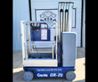 Genie GR-20 vertical mast lift, blue, side view: mast lowered, platform with guardrails, solid non-marking tires