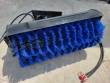 Angle broom with full-width blue bristle roller under a black hood, mount plate and hydraulic hoses