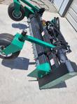 Carbide-tooth drum of the soil conditioner with its end drive motor and green gauge wheels raised