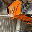 Landhonor cement mixer bucket on skid steer arms, discharge chute and hose below the drum; example photo