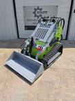 ATS T460 stand-on mini skid steer, front 3/4 view with bucket lowered and dual control levers up top