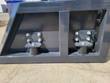 Back of the screening bucket showing the skid steer quick-attach mounting plate and its two lock pins.