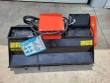 Black flail mower deck with orange drive cover, hydraulic motor, hose bundle and AGT spec tag