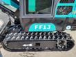 FF13 rubber track and steel drive sprocket below the black upper housing, with the model decal and EPA label