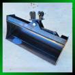 Black 32-inch tilt bucket at an angle, smooth no-teeth cutting edge, tilt cylinder and twin-pin mounting bracket