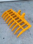 Yellow excavator root rake, eight curved tines on a tubular frame with twin pin-boss mounts