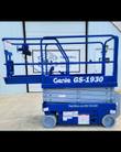 Genie GS-1930 scissor lift in blue with the slide-out extension deck pushed out, guardrails up, platform lowered