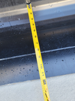 32-inch tilting bucket's smooth interior, tape measure laid across it
