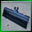 Black 40-inch tilt bucket at an angle, smooth no-teeth cutting edge, tilt cylinder and twin-pin mount