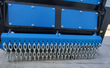 Drum mulcher front with bolted access covers and a row of hanging galvanized chain shielding, blue housing