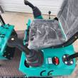 AGT MH12RX operator seat in factory wrap, twin pilot joysticks and the red hydraulic lock lever on the console
