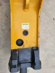 SB40's GREASING label and two grease ports above the black chisel bushing housing