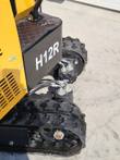 H12R decal on the AGT mini excavator counterweight, with track drive motor, hydraulic hoses and rubber tracks