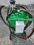 DB500 blast pot from above: green tank, push handle, white lockable control box with key, wheels and hoses