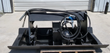 JCT vibratory plate compactor: black steel plate with hydraulic motor and looped hoses on a quick-attach frame