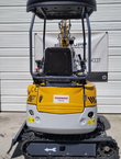 SDLE20 mini excavator from behind: yellow and white engine cowl and counterweight, seat and canopy, rubber tracks
