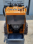 QB-480 mini skid steer from the rear: control panel, cooling fan on the gas engine and stand-on operator platform
