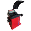 Red computer wheel balancer, front 3/4 view, hood raised, weight cups, control panel and wheel-mount shaft