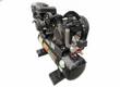 Black gas-engine air compressor from the rear corner: mesh belt guard, pressure gauge, red ball valves and steel skid feet