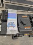 Engine fuel tank with filler cap and warning labels, operation instruction booklet in a clear bag lying on top