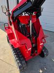 Hydraulic hoses and cylinder at the loader arm pivot on the AGT SDA-140T mini skid steer