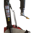 Tire changer tower close-up: warning labels and pneumatic duck head mounting clamp