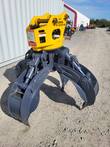 ALSEG08 rotating grapple, rear three-quarter view, yellow head with warning decals, open gray tines and cylinders