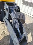 Grapple tine cylinder with valve block and spiral-wrapped hoses, rod end pinned to the gray tine