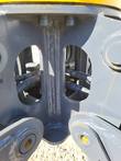 Grapple center frame with welded gusset, hydraulic hoses and fittings seen through the frame cutouts
