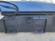 Skid-steer quick-attach plate on the Arteer box broom, two mounting slots and a coiled hose
