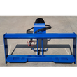 Blue skid steer quick-attach mounting plate with the auger drive and red-capped hydraulic couplers behind it