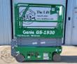 Green Genie GS-1930 scissor lift, platform lowered with guardrails up and the control box on the rail