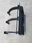 Ripper from the side: quick-attach mount plate with mounting slots and three curved shanks with boot tips