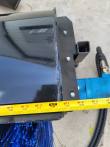 Tape measure across the angle broom's black hood and end plate, reading about 48 inches