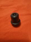 Black round hydraulic filter bypass valve housing with a flange ring and a center bore at the top