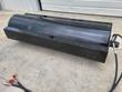 Vibratory roller drum from above, rows of raised square compaction pads across the full width