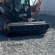 Wolverine vibratory roller mounted on a JCB track loader, drum compacting a gravel pad