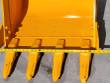Tape measure across the yellow bucket's cutting edge, four teeth cast PC-60 hanging below