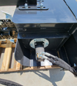 Wolverine trencher gearbox housing, hydraulic motor with DIN-rated hoses connected, quick-attach mount above