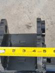Tape measure across the tilt bucket's mounting bracket pin ears, spanning about 5 inches
