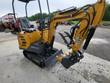 AGT DM12-C mini excavator from the rear: canopy, wrapped seat, boom out with the hydraulic thumb open above the bucket