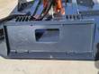 Brush cutter's universal quick-attach mounting plate, with the orange hydraulic motor and hoses above the deck