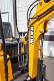 MIVA VA15 yellow boom with hydraulic hoses and cylinder, the T-handle levers and seat behind it