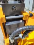 Post driver piston housing and valve block in the yellow frame: cross pin, IN port and hydraulic hoses