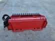 Red power rake from the back: universal skid steer quick-attach plate, coiled hoses and black leveling teeth